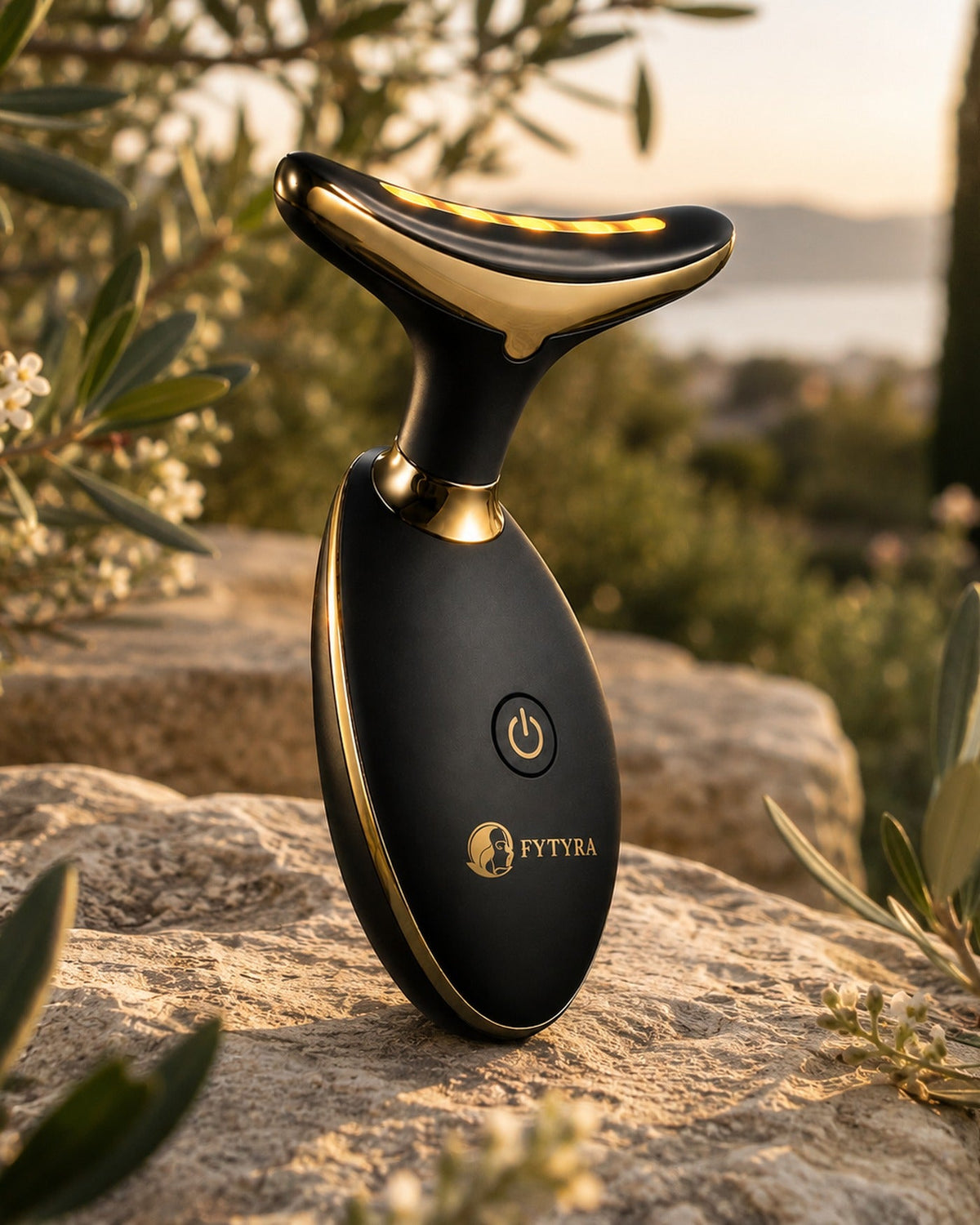 The Fytyra Sculpting Device in Midnight on a stone wall in an olive grove at sunset