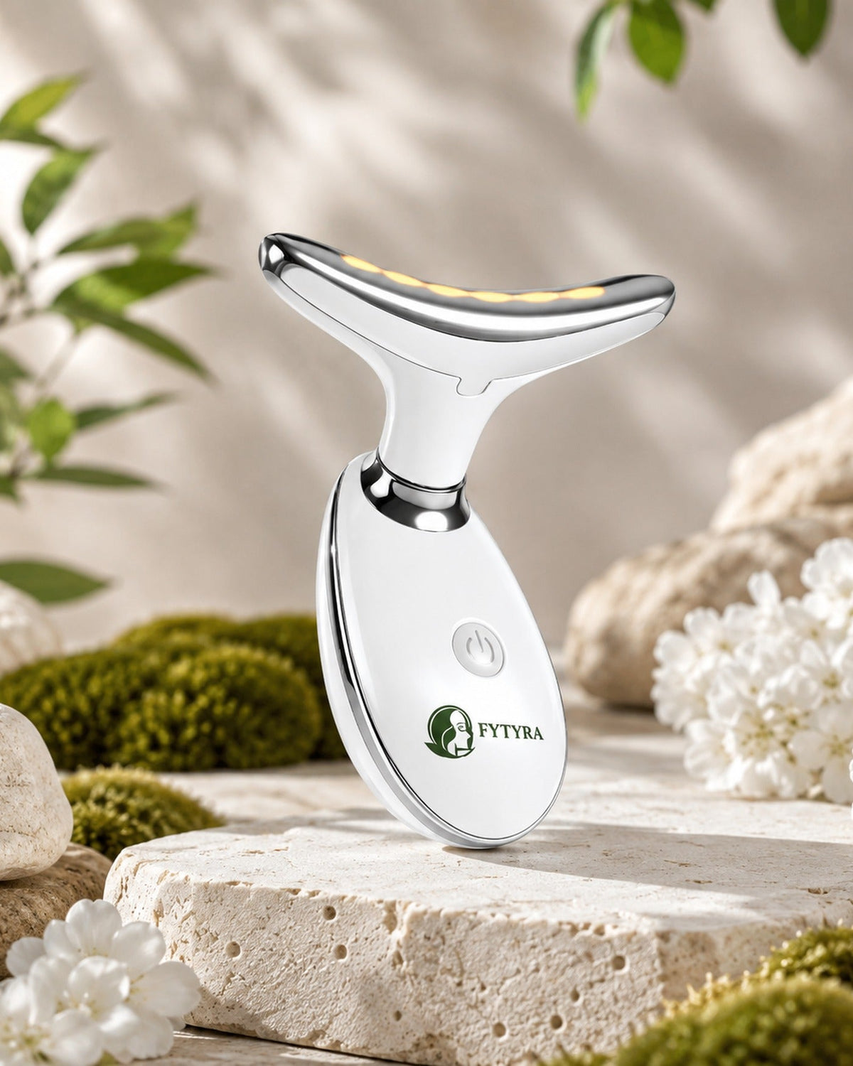 The Fytyra Sculpting Device in White on travertine among moss and white blossom