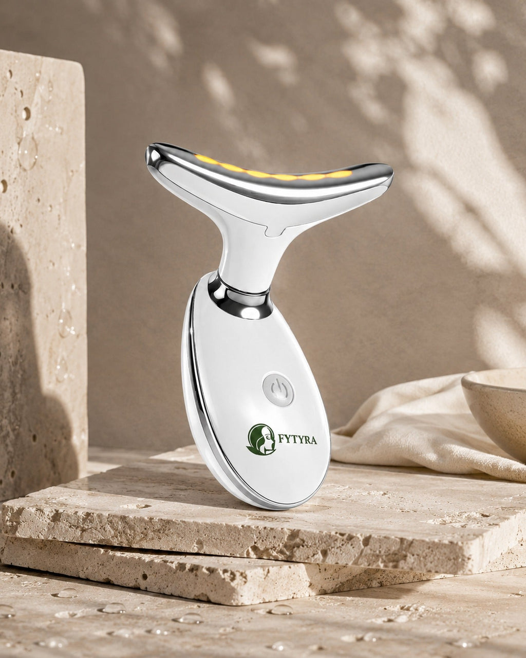 The Fytyra Sculpting Device in White on a travertine ledge in warm daylight